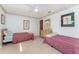 Bedroom with hardwood floors, neutral paint, and a ceiling fan, furnished with two twin beds at 11453 Oceanspray Blvd, Englewood, FL 34224