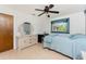 Bedroom featuring light walls, light wooden floors, and a bed beneath a window at 11453 Oceanspray Blvd, Englewood, FL 34224