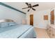 Bedroom with light blue walls, ceiling fan, and a bed with a window at 11453 Oceanspray Blvd, Englewood, FL 34224