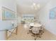 Bright dining room with chandelier lighting and views of the front yard at 11453 Oceanspray Blvd, Englewood, FL 34224