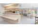 Bright kitchen with breakfast bar and tile floors that leads to the dining area at 11453 Oceanspray Blvd, Englewood, FL 34224