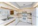 Bright kitchen featuring white appliances, ample counter space, and lots of upper cabinet storage at 11453 Oceanspray Blvd, Englewood, FL 34224
