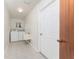 Laundry room with washer, dryer, sink, and tiled flooring at 11453 Oceanspray Blvd, Englewood, FL 34224