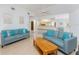Well-lit living room with neutral paint, hardwood floors, updated furniture, and access to other rooms in the house at 11453 Oceanspray Blvd, Englewood, FL 34224