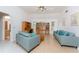 Bright living room with vaulted ceilings, light floors, updated furniture, and a built-in entertainment center at 11453 Oceanspray Blvd, Englewood, FL 34224