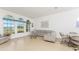 Bright living room with large windows, tile floors, and cozy seating at 11453 Oceanspray Blvd, Englewood, FL 34224