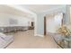 Spacious living room with light wood floors leading to the dining room and front entrance at 11453 Oceanspray Blvd, Englewood, FL 34224