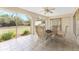Sunroom with tiled floors, ceiling fan, and views of the backyard at 11453 Oceanspray Blvd, Englewood, FL 34224