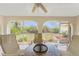 Sunroom with tiled floors, ceiling fan, seating area, and views of the backyard at 11453 Oceanspray Blvd, Englewood, FL 34224