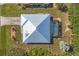 Aerial view of the property featuring a metal roof and screened pool enclosure at 12028 Newgate Ave, Port Charlotte, FL 33981