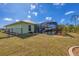 The expansive backyard features a screened pool area, grill and well-maintained lawn at 12028 Newgate Ave, Port Charlotte, FL 33981