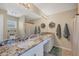 Bathroom with dual sinks, large mirror, and granite countertop at 12028 Newgate Ave, Port Charlotte, FL 33981