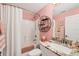 Pink bathroom featuring a shower and granite countertop vanity at 12028 Newgate Ave, Port Charlotte, FL 33981