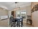 Bright dining room with a modern light fixture and a table set for four at 12028 Newgate Ave, Port Charlotte, FL 33981