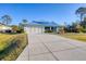 Well-maintained one-story home featuring a pristine driveway and well-kept landscaping at 12028 Newgate Ave, Port Charlotte, FL 33981
