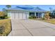 Beautiful one-story home with a garage and a large concrete driveway at 12028 Newgate Ave, Port Charlotte, FL 33981