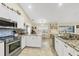 Open kitchen with stainless steel appliances and granite countertops at 12028 Newgate Ave, Port Charlotte, FL 33981