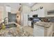 Kitchen featuring granite counters, stainless steel appliances, and tile backsplash at 12028 Newgate Ave, Port Charlotte, FL 33981
