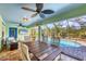 Inviting screened lanai featuring a dining area, ceiling fans, and views of the sparkling pool at 12028 Newgate Ave, Port Charlotte, FL 33981