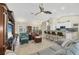 Open concept living room with vaulted ceiling, tile floors, comfortable seating, and seamless access to the dining room at 12028 Newgate Ave, Port Charlotte, FL 33981