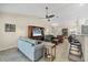 Open concept living room with vaulted ceiling, tile floors, comfortable seating, and seamless access to the dining room at 12028 Newgate Ave, Port Charlotte, FL 33981