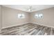 Spacious bedroom with stylish wood flooring, neutral walls, and bright natural light at 1313 Buereau Rd, Englewood, FL 34223