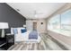Bedroom with a dark accent wall, wood-look flooring, barn door and a large window at 1313 Buereau Rd, Englewood, FL 34223
