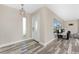 Well-lit foyer with decorative lighting fixture and wood-look flooring leads to the living room at 1313 Buereau Rd, Englewood, FL 34223