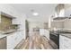 Bright kitchen featuring stainless steel appliances, granite countertops and wood-look flooring at 1313 Buereau Rd, Englewood, FL 34223