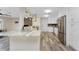 Bright kitchen featuring stainless steel appliances, white cabinetry and a granite countertop peninsula at 1313 Buereau Rd, Englewood, FL 34223