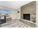 Bright living room featuring a stone fireplace, and a large window with plenty of natural light at 1313 Buereau Rd, Englewood, FL 34223