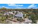 An aerial view of the home featuring a metal roof, lush greenery, and beautiful surrounding homes at 1320 Bayshore Dr, Englewood, FL 34223