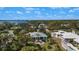 An aerial view of the property showcasing the home, landscaping, and serene waterfront neighborhood at 1320 Bayshore Dr, Englewood, FL 34223
