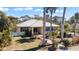A beautiful single-story home with a metal roof, blue shutters, and well-maintained landscaping at 1320 Bayshore Dr, Englewood, FL 34223