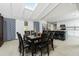 Bright dining area with skylights, table with seating for eight, and open layout to kitchen at 13360 Foresman Blvd, Port Charlotte, FL 33981