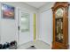 The entryway features a decorative front door, light tile flooring, and a classic grandfather clock at 13360 Foresman Blvd, Port Charlotte, FL 33981