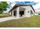 This single-story home features a covered porch with brick supports and a well-kept lawn at 13360 Foresman Blvd, Port Charlotte, FL 33981