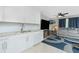 Open kitchen featuring white cabinets, granite countertops, stainless steel appliances, and tile floors at 13360 Foresman Blvd, Port Charlotte, FL 33981