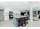 Stylish kitchen island with bar stool seating and views into the living room with comfy sectional at 13360 Foresman Blvd, Port Charlotte, FL 33981