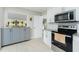 Bright kitchen featuring white cabinets, granite countertops, stainless steel appliances, and tile floors at 13360 Foresman Blvd, Port Charlotte, FL 33981