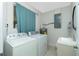 Functional laundry room featuring a washing machine, dryer, utility sink, and water heater at 13360 Foresman Blvd, Port Charlotte, FL 33981