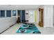 Bright living room featuring tile floors, gray sofa, and a decorative rug at 13360 Foresman Blvd, Port Charlotte, FL 33981