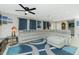 Inviting living space with a comfortable sectional sofa, art, and a unique area rug at 13360 Foresman Blvd, Port Charlotte, FL 33981