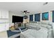 Comfortable living room features a plush sectional sofa, ceiling fan, and modern entertainment center at 13360 Foresman Blvd, Port Charlotte, FL 33981