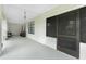 The outdoor porch features ample seating with neutral gray paint and decor at 13360 Foresman Blvd, Port Charlotte, FL 33981