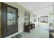 A spacious porch offers comfortable seating and an elegant glass-paneled front door at 13360 Foresman Blvd, Port Charlotte, FL 33981