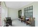 The covered porch is furnished with comfortable wicker chairs, creating an inviting outdoor space at 13360 Foresman Blvd, Port Charlotte, FL 33981