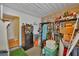 Unfinished basement area featuring ample storage shelving, and a refrigerator at 13559 Martha Ave, Port Charlotte, FL 33981
