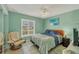 Cozy bedroom with a queen-size bed, tile floors, and ample natural light from the window, creating a tranquil retreat at 13559 Martha Ave, Port Charlotte, FL 33981