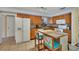Functional kitchen with ample counter space, wooden cabinetry, and a center island with seating at 13559 Martha Ave, Port Charlotte, FL 33981